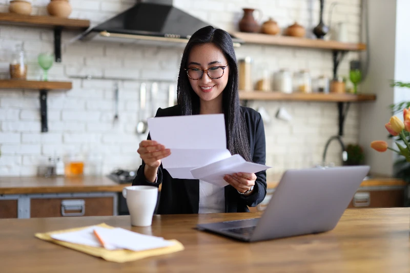 Businesswoman happy reads a finance letter at her desk